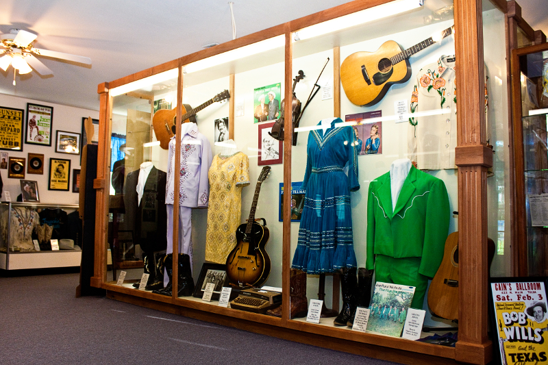 Museum display case featuring itms from Bob Wills and several other country music stars